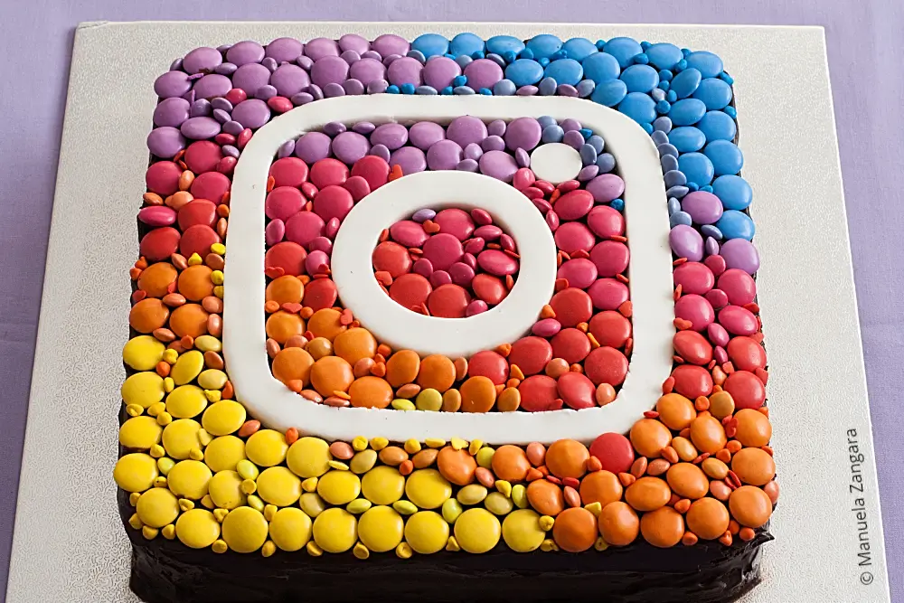 Finished Instagram Cake decorated with coloured chocolates and fondant logo.