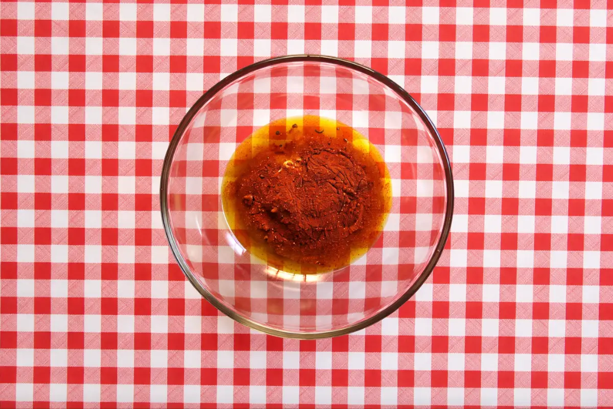 Paprika and oil combined in a bowl for low FODMAP chicken marinade.