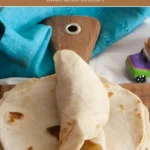 Folded tortilla showing pliable texture with teal napkin.