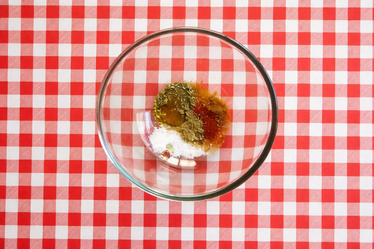 Homemade low fodmap fajita seasoning mixed with oil and spices in a bowl.