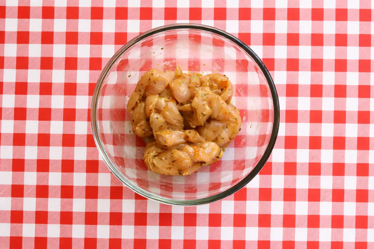 Sliced chicken coated in a simple low fodmap fajita seasoning before marinating.