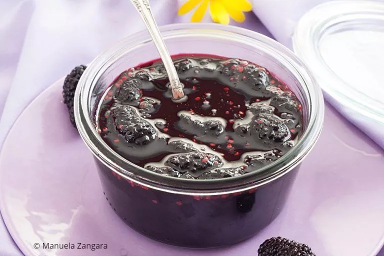 Homemade mulberry jam stored in a clear glass jar.