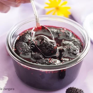 Finished mulberry jam stored in a glass jar.