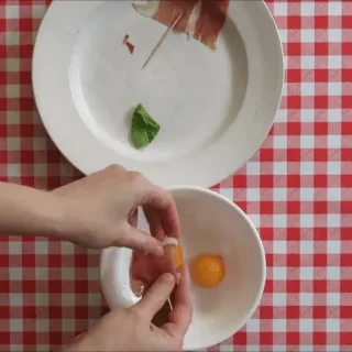 olding prosciutto over melon balls before adding mint and securing with a toothpick.
