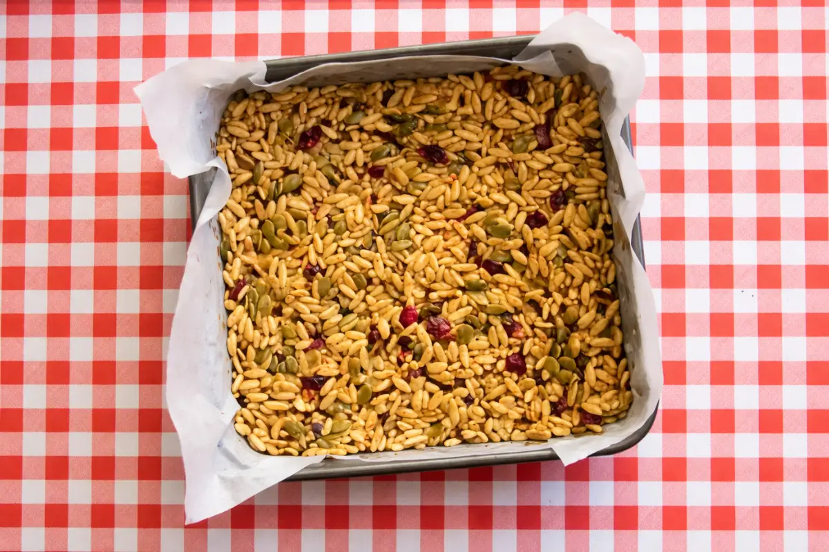 Low fodmap bars mixture pressed evenly into a lined square baking pan.