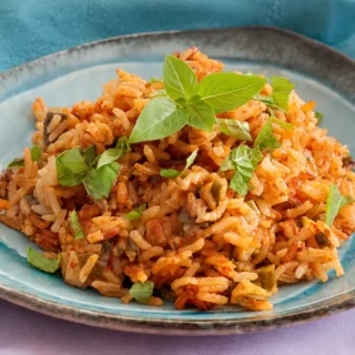 Low FODMAP rice with tomato and basil served warm.