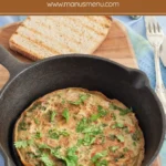 Low FODMAP Masala Omelette served in a cast iron pan with toasted bread on the side.