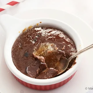 Close-up of chocolate custard with caramelised sugar served in a ramekin.