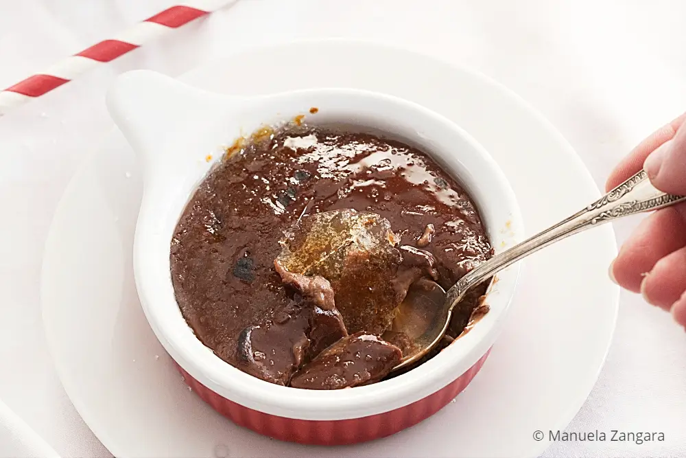 Close-up of chocolate custard with caramelised sugar served in a ramekin.