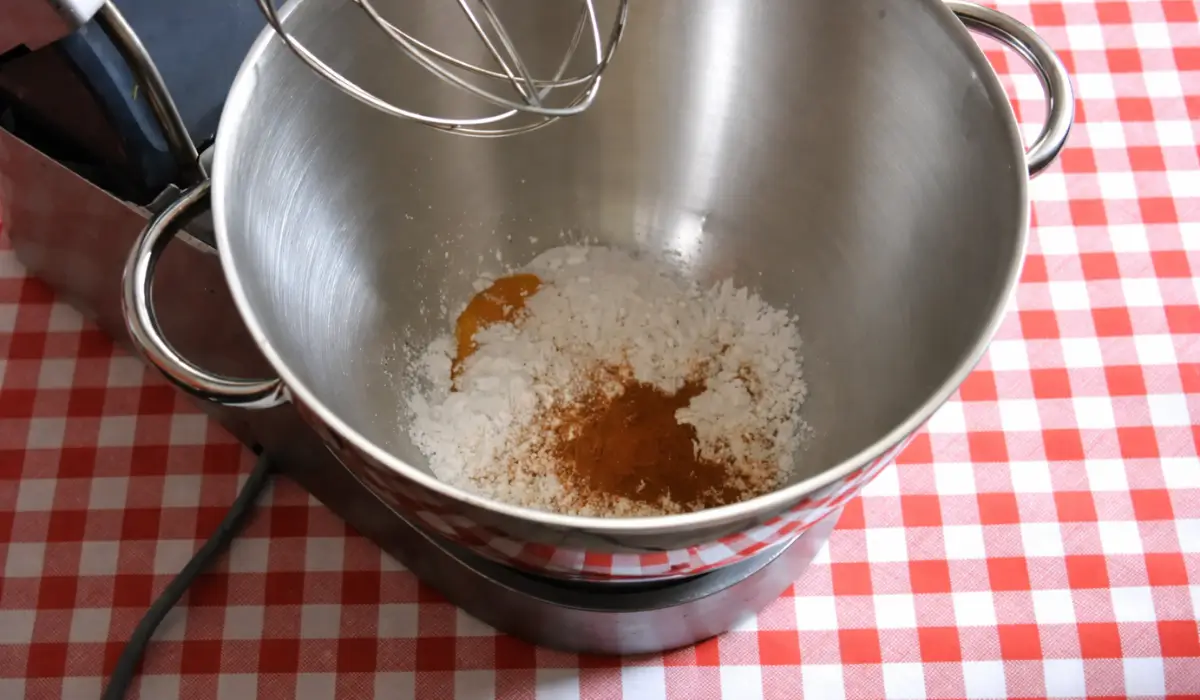 Egg yolks, sugar, cinnamon, and cornstarch in a mixing bowl before whisking.