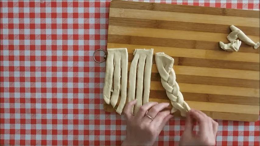 Braiding strips of syrup dough pastry for traditional koeksisters.