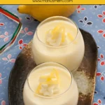 Two glasses of easy Lemon Panna Cotta dessert with whipped cream and lemon garnish.