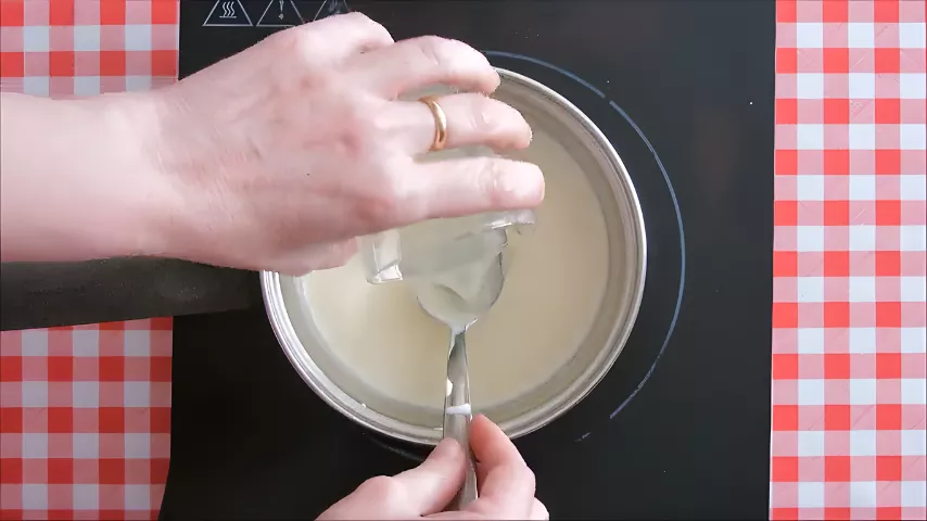Warming milk, cream, and sugar in a saucepan to make Italian Lemon Panna Cotta.