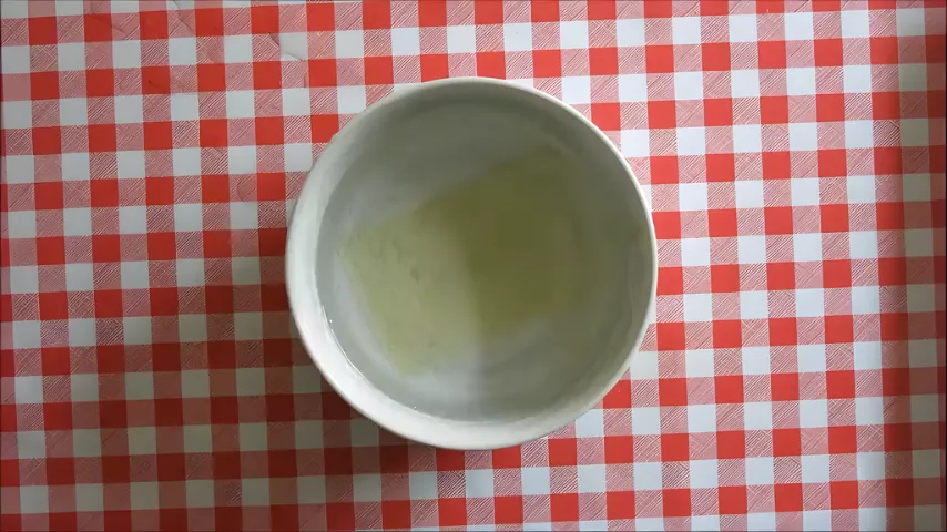 Bowl of gelatine sheets soaking in cold water for Lemon Panna Cotta.