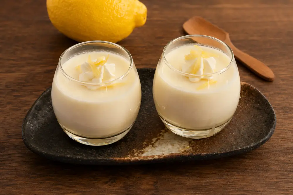 Two glasses of Lemon Panna Cotta served on a platter.