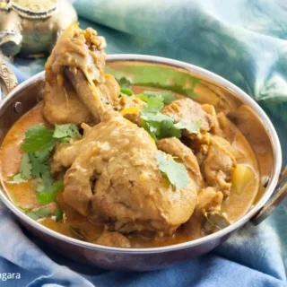 Low FODMAP chicken curry served with potatoes and coriander.