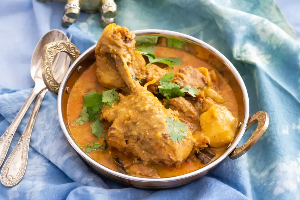 Creamy Low FODMAP Chicken Curry served with fresh herbs.