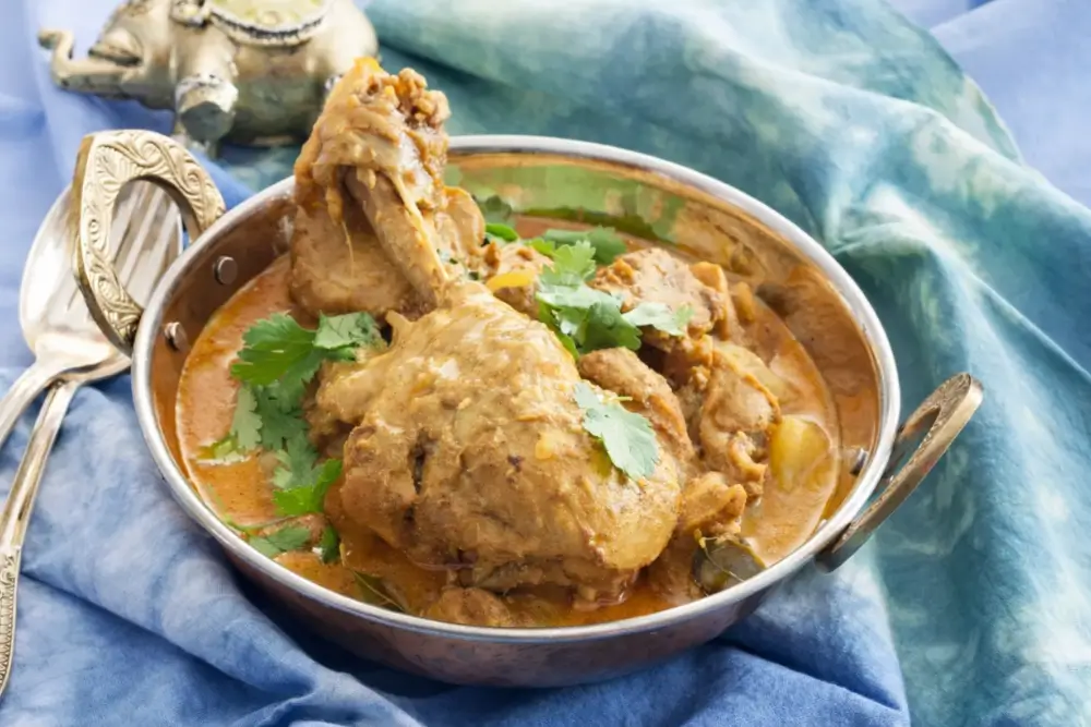 Low FODMAP Chicken Curry with tender potatoes and herbs in a rich sauce.
