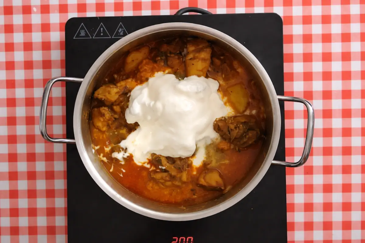 Yoghurt and cream added to the chicken curry before the final simmer.
