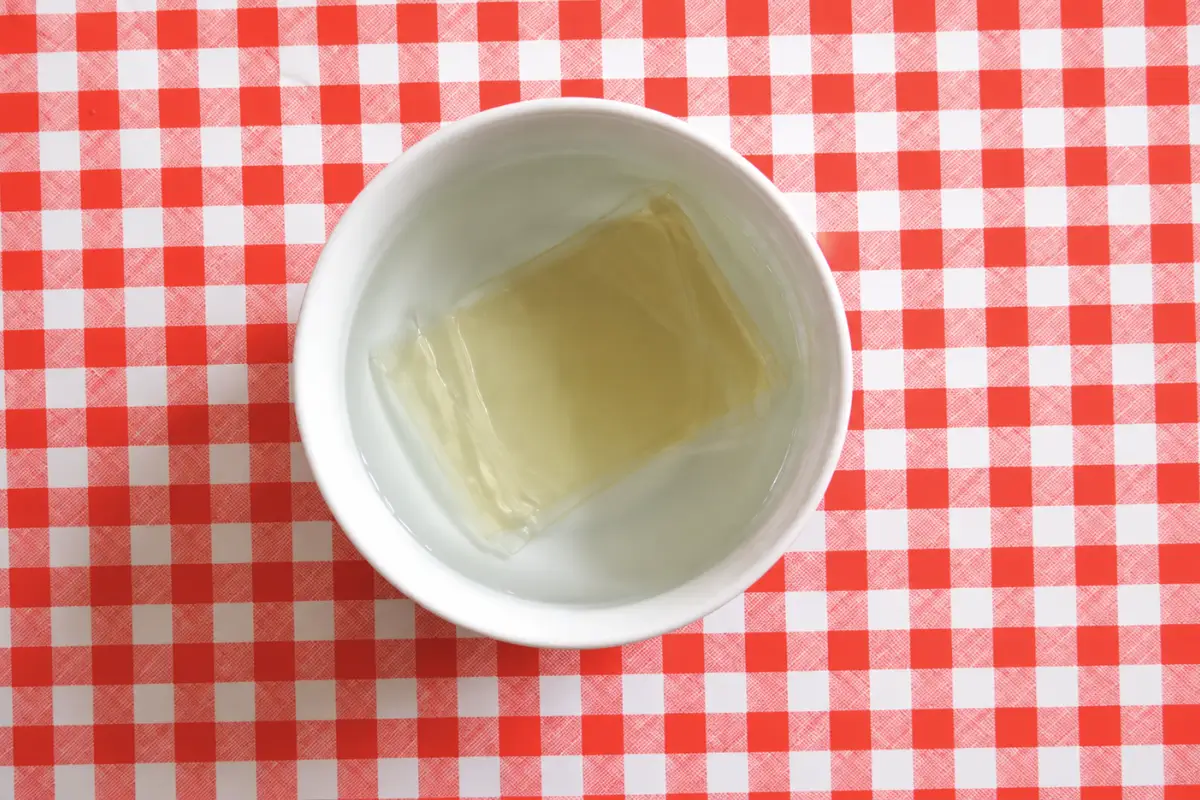 Gelatine sheets soaking in cold water before being added to the cream mixture.