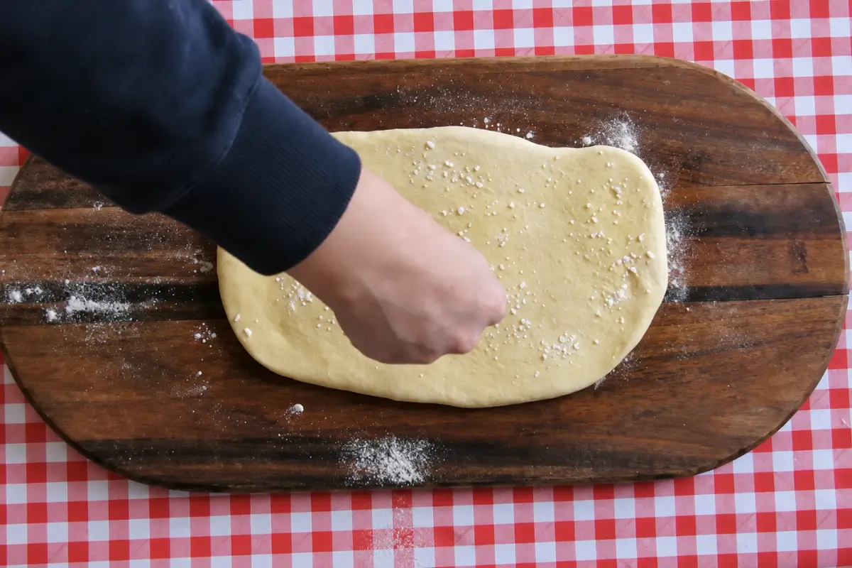 Dusting Sourdough Grissini dough with semolina after brushing the surface with extra virgin olive oil.