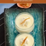 Two glasses of chilled yuzu panna cotta on a blue serving tray.