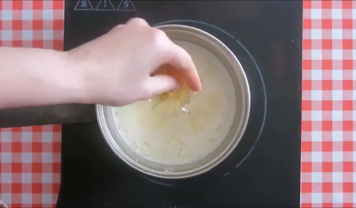 Adding softened gelatine to the warm cream mixture.