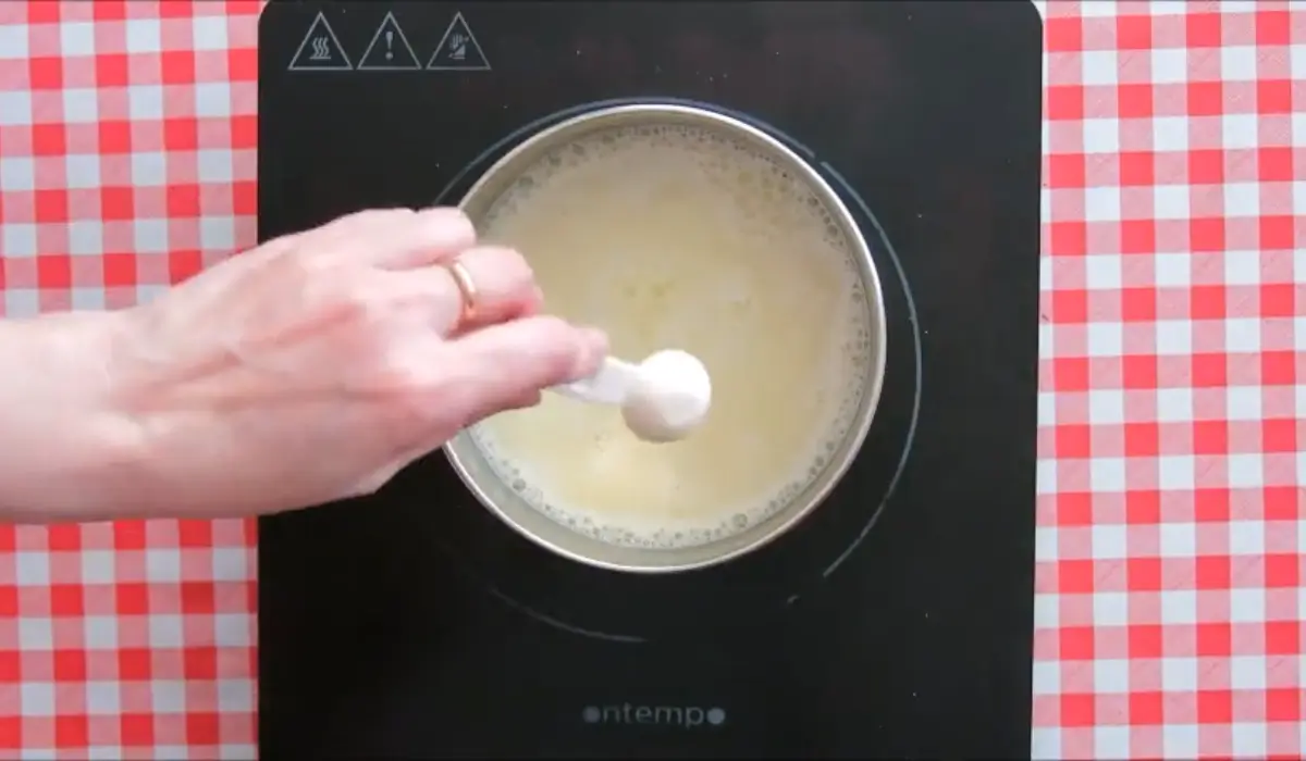 Adding yuzu essence to the warm dairy mixture.