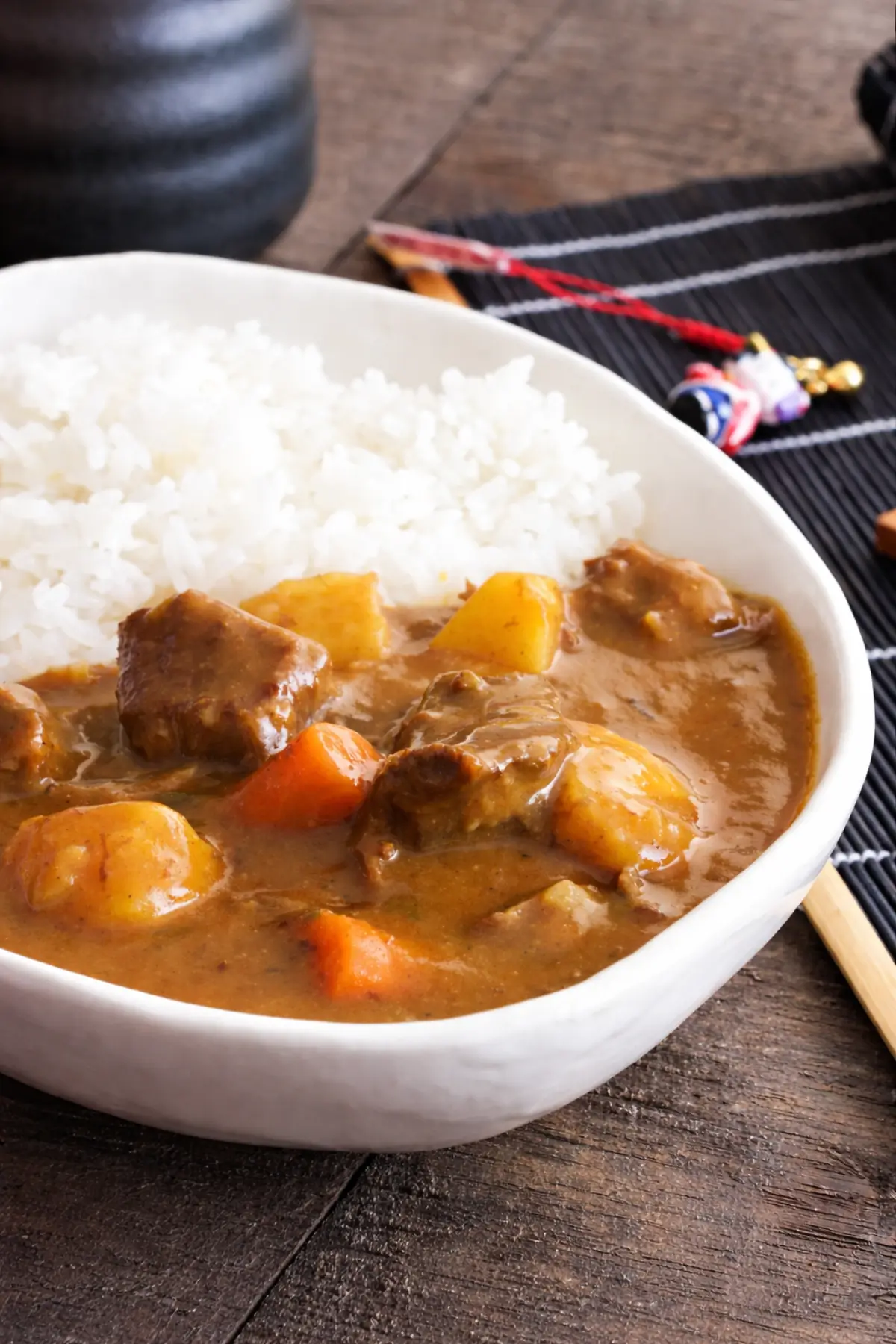 Close-up of Japanese beef curry with a smooth sauce coating beef, carrots, and potatoes.