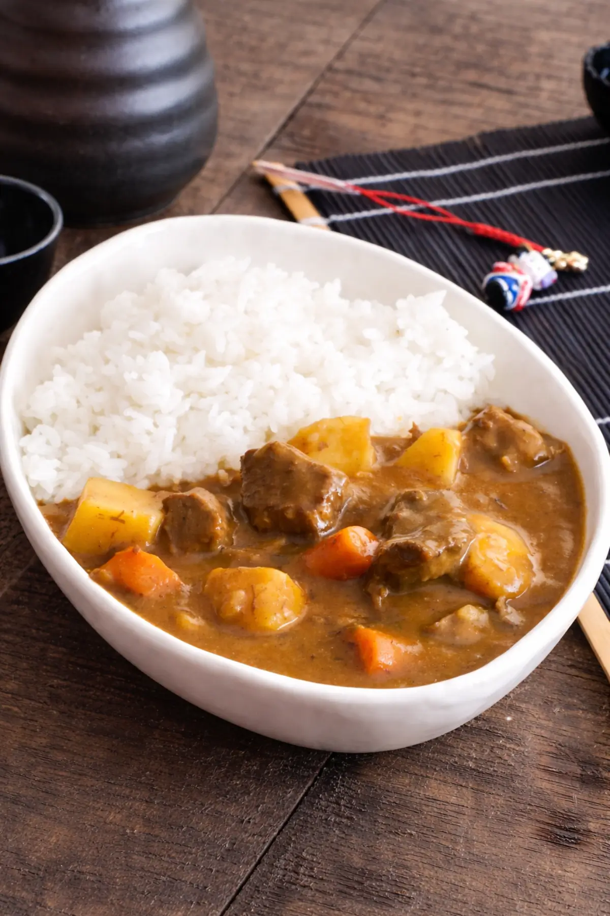 Japanese curry fodmap style served in a white bowl with rice, beef, and vegetables.