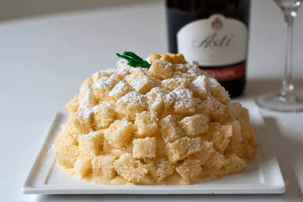 Classic Torta Mimosa made with layers of Italian sponge cake, filled with cream and topped with sponge cubes.