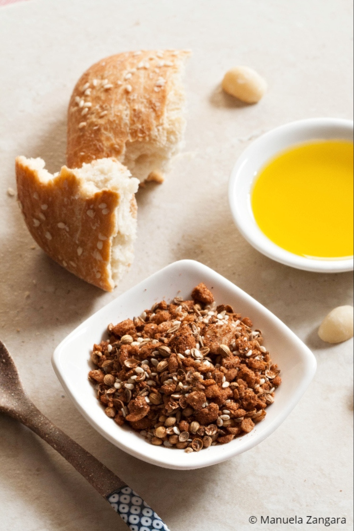 Small bowl of dukkah served with olive oil and bread.
