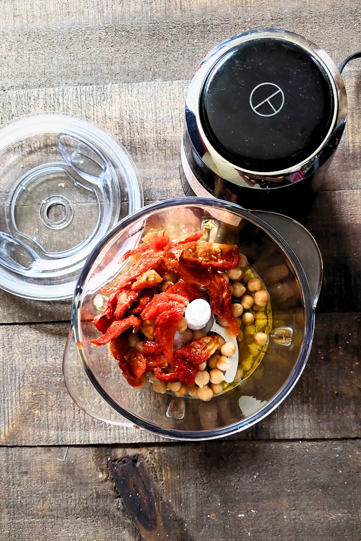 Chickpeas, sun-dried tomatoes and olive oil in a food processor before blending.