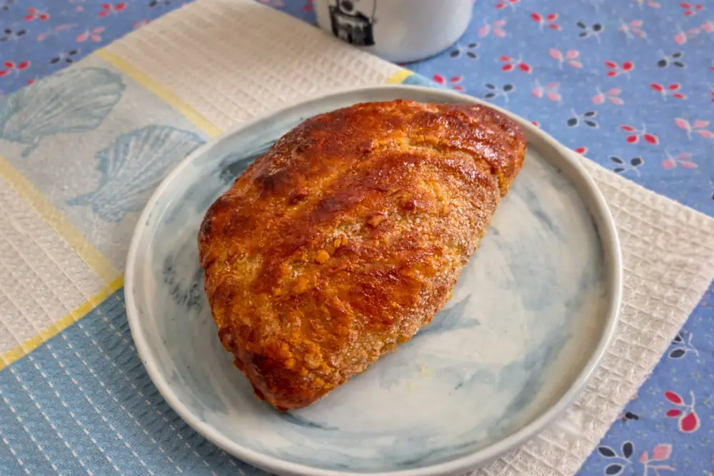 Crisp, golden sugar-coated pastry served on a plate with a lightly caramelised surface.