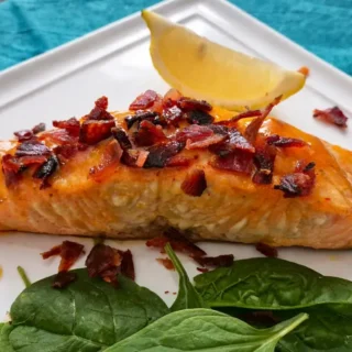 Maple and Sriracha Salmon with Bacon Crumbs served with crispy topping and lemon on the side.