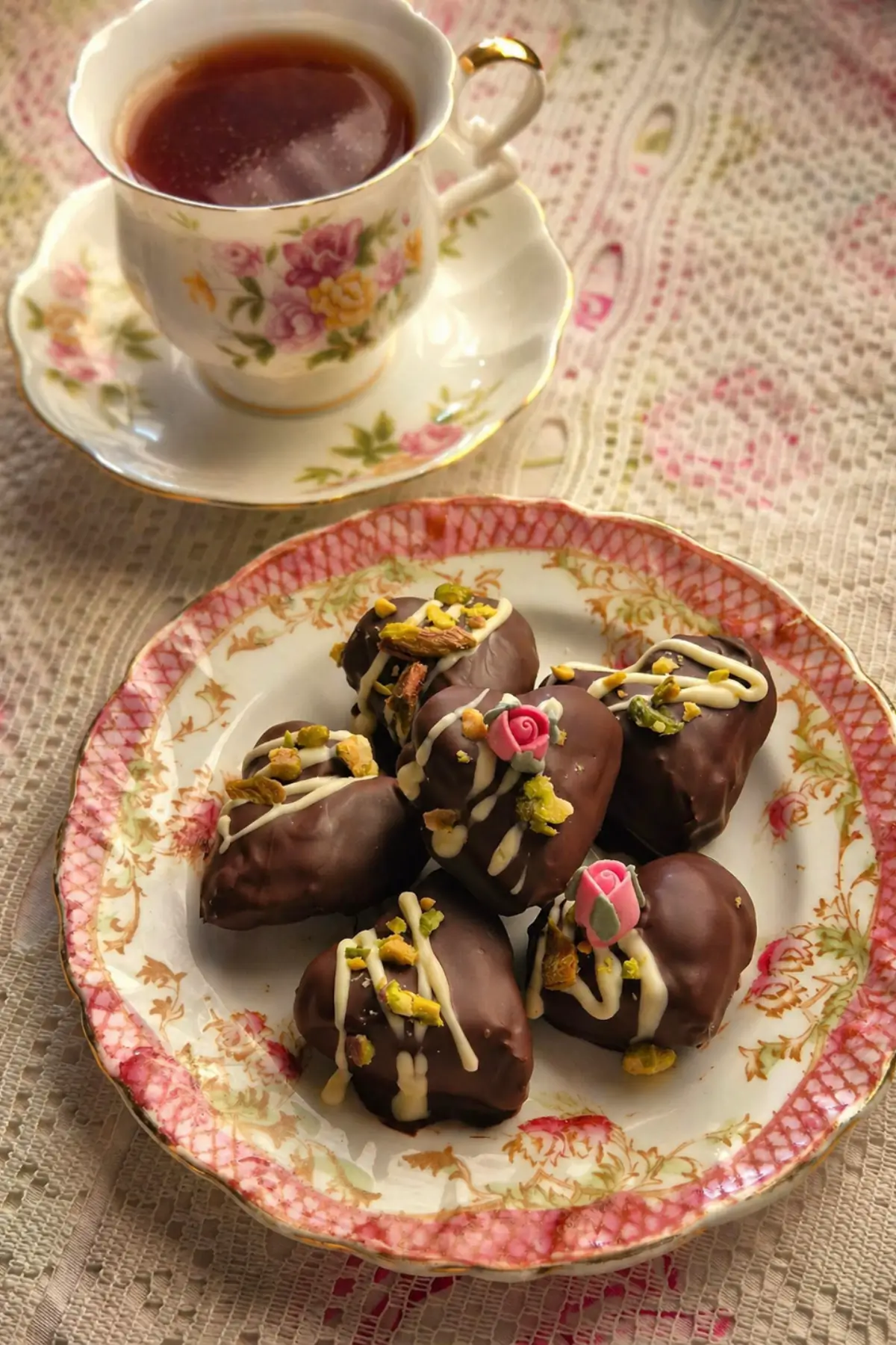 Chilled chocolate treats arranged on a floral plate with pistachios and white chocolate drizzle.