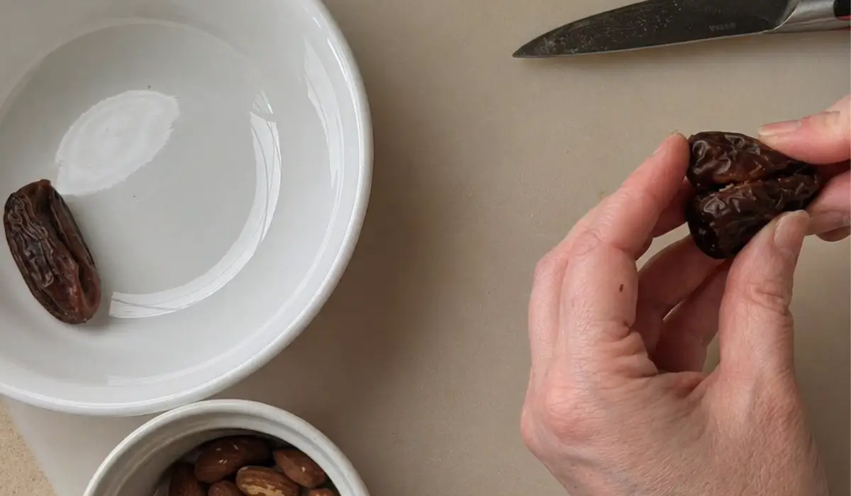 Pressing the date halves together to create heart shapes.