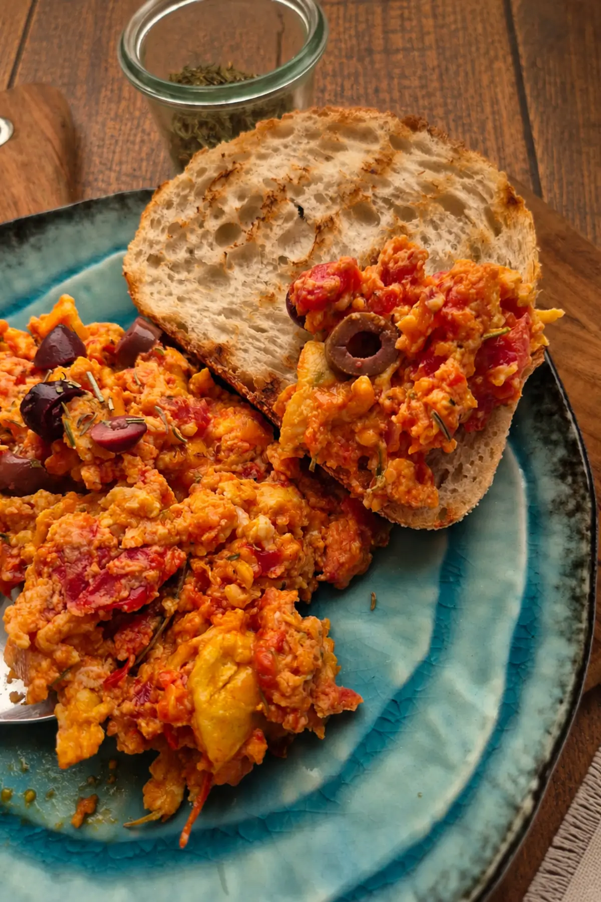 Soft eggs in tomato sauce spooned over toasted bread.
